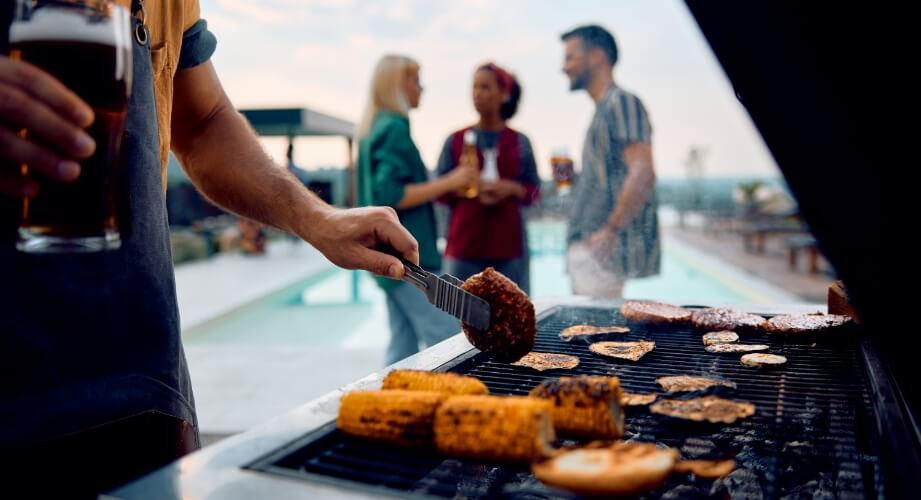 Friends grilling out by the pool.