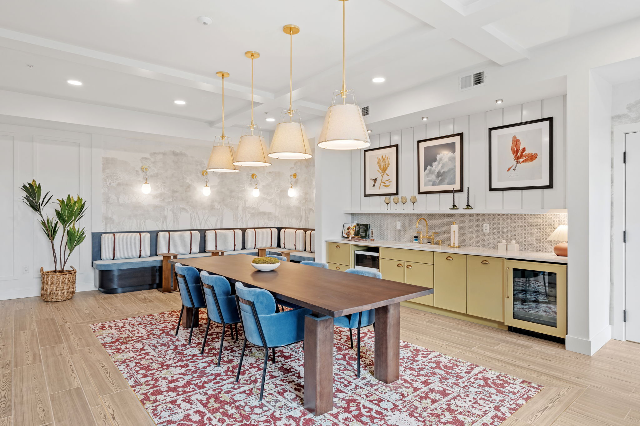 Community room with seating and large table facing wet bar and sink