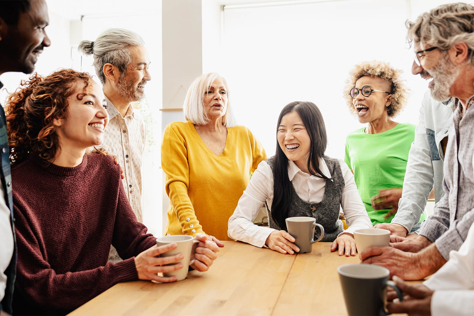 Group of diverse adults enjoying a conversation around a table