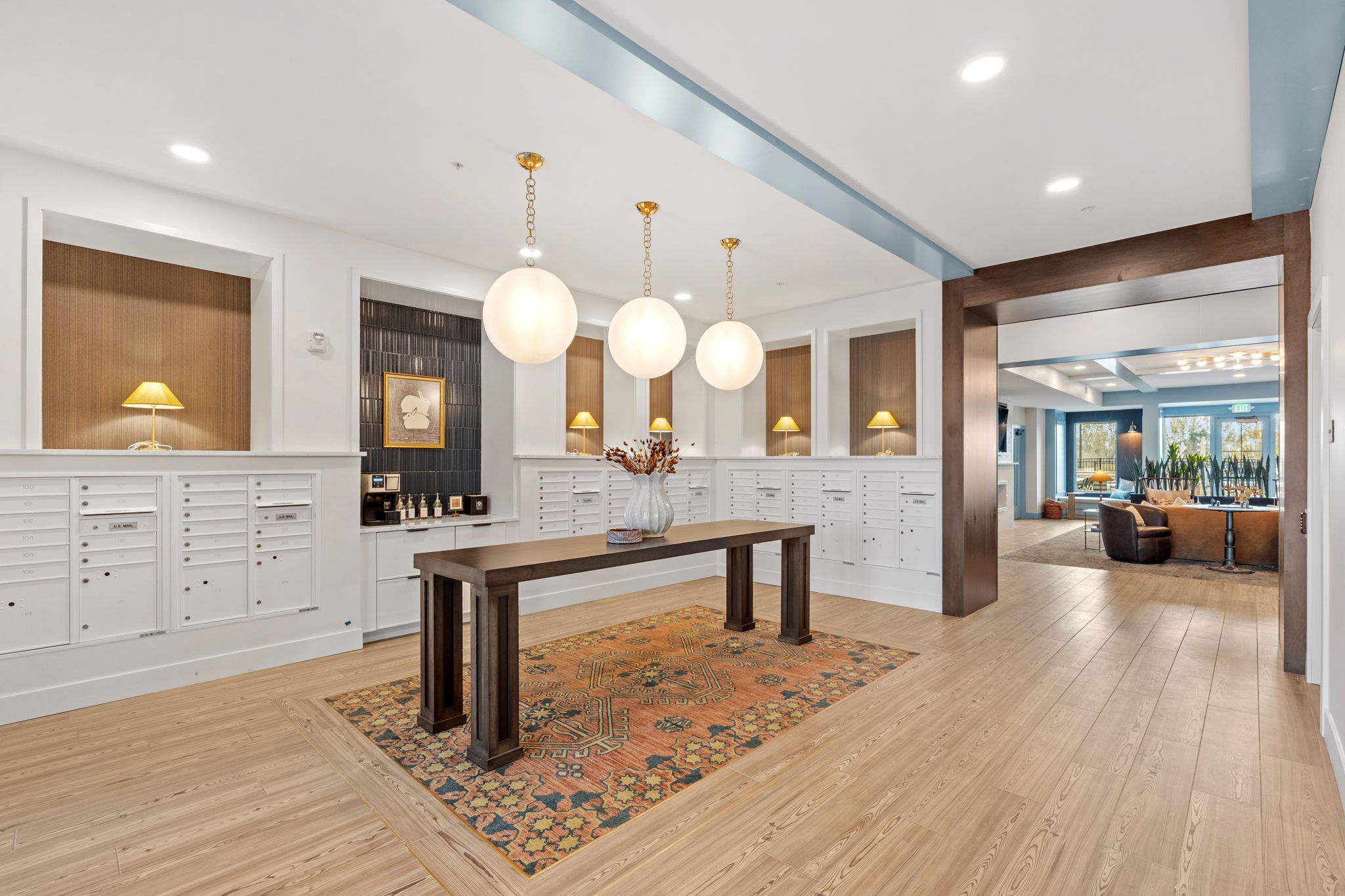 Lobby with mail boxes, table, and coffee bar
