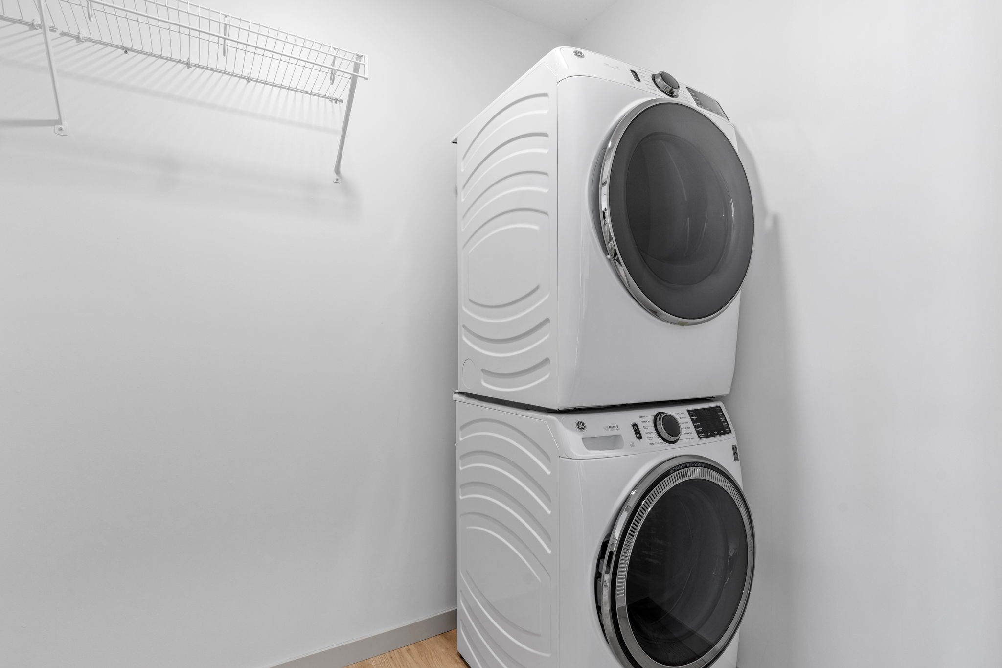 Laundry room with stacked front load washer and dryer