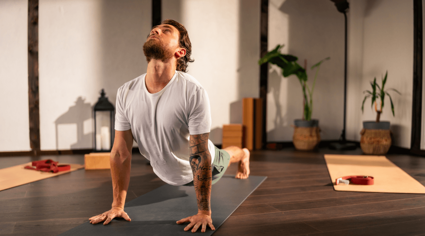 Man doing a yoga pose indoors on a mat