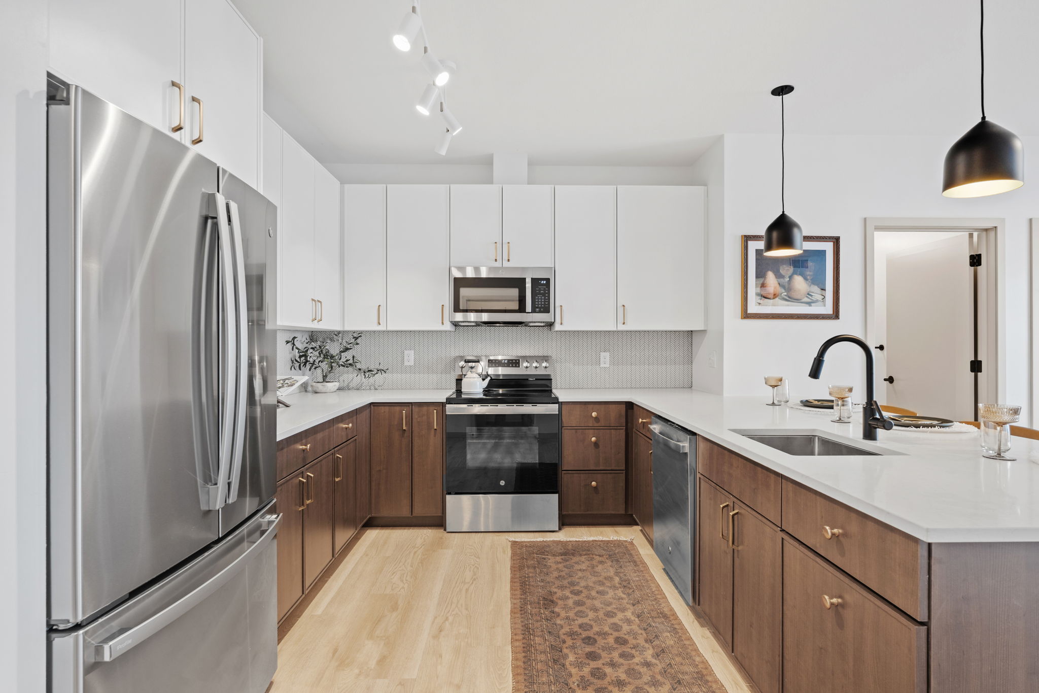 kitchen area with cabinets and fridge in view