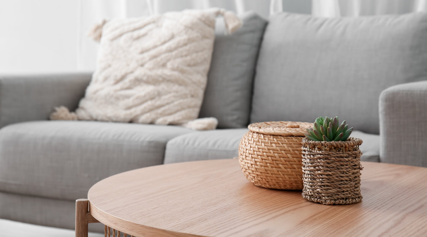 Cozy living room with a gray couch and wicker basket decor on a wooden coffee table