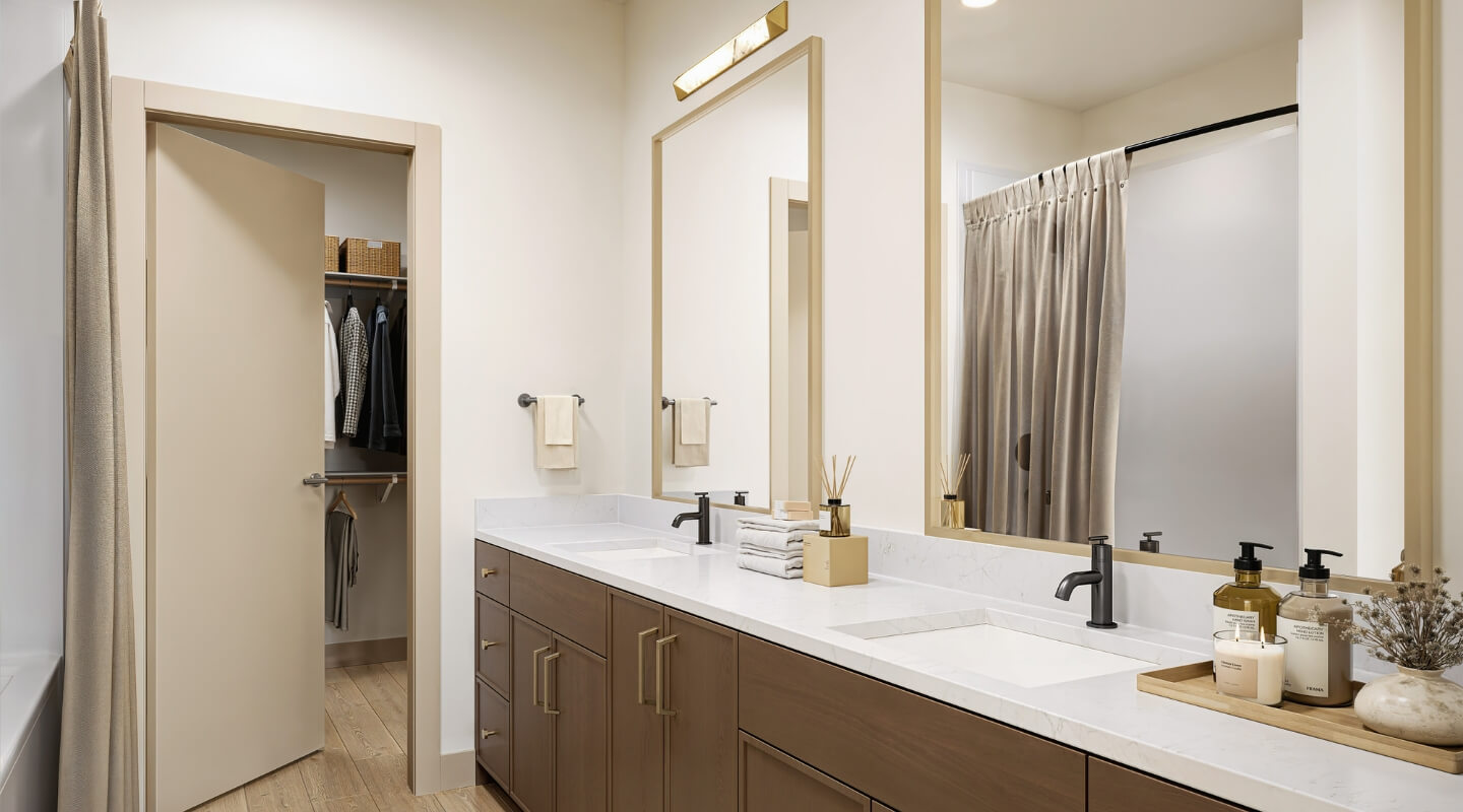 A Rye Apartments bathroom with 2 sinks and a door to the closet