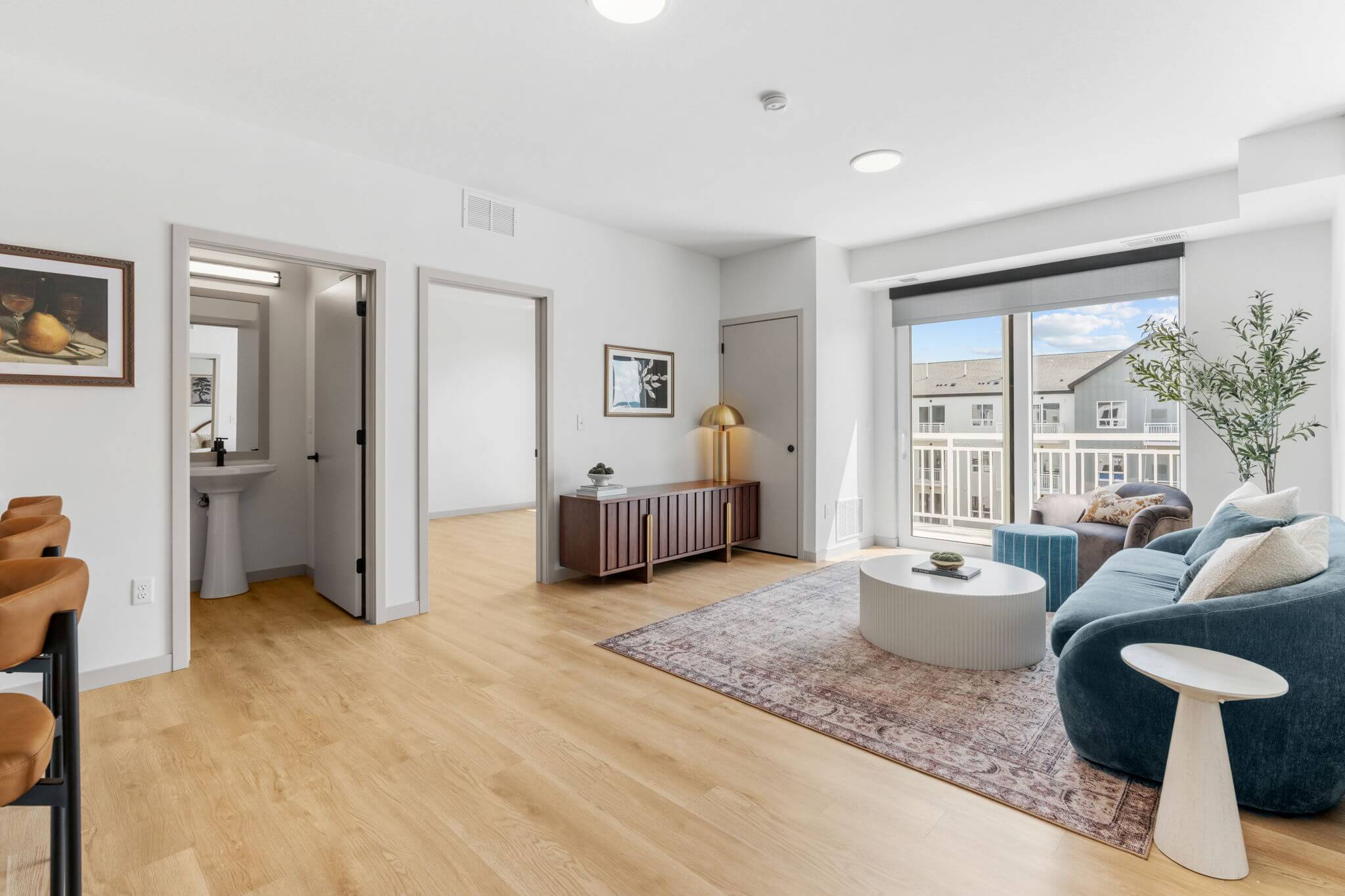 Living room with open doorway to bedroom and natural light from sliding glass door